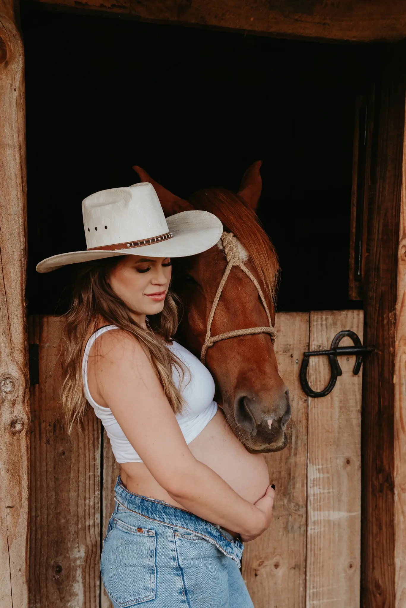 Gestante junto a um cavalo durante ensaio